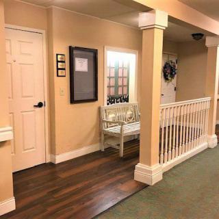 A cozy hallway with a bench, a door, and decorative elements.