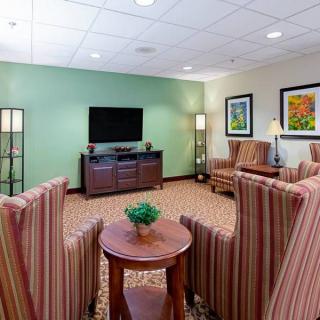 A cozy living room with a television and comfortable seating arrangement.