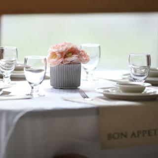 An elegantly set dining table adorned with flowers, perfect for a special occasion.