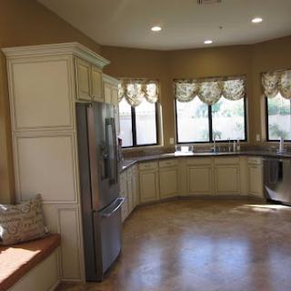 A bright and inviting kitchen featuring modern appliances and a curved layout, perfect for cooking and entertaining.