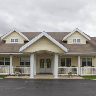 A suburban residential house with a porch and gabled roof.
