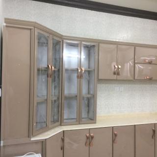 A modern kitchen featuring elegant cabinets with glass doors.
