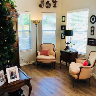 A cozy living room corner with elegant chairs and festive decor.