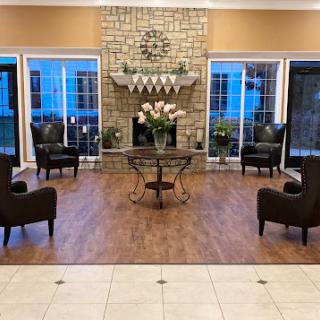 A cozy living room setup featuring elegant seating and a stylish fireplace.