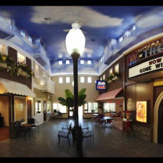 A beautifully designed indoor shopping area featuring a decorative ceiling and inviting seating.