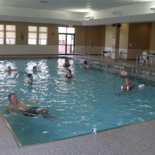People enjoying a swim in an indoor pool.