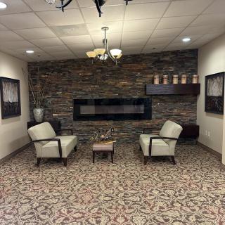 Cozy lobby area with a modern fireplace and elegant seating.
