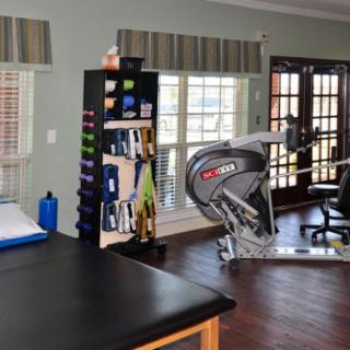 A well-equipped home gym featuring a stationary bike and various exercise gear.