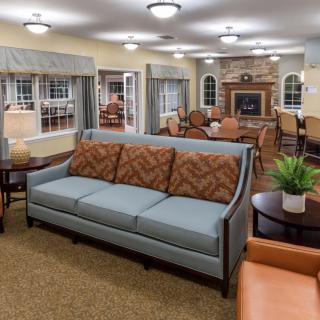 A cozy living room with a sofa, fireplace, and elegant furnishings.