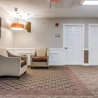 A modern waiting room with comfortable seating and soft lighting.