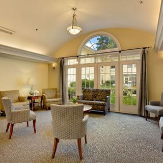 A cozy living room with comfortable seating and large windows letting in natural light.