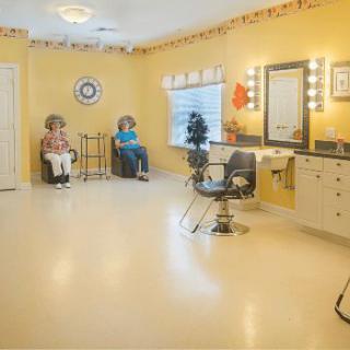 A well-lit hair salon with styling chairs and mirrors, featuring a bright and welcoming interior.
