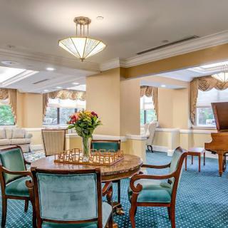 Elegant dining room with a chess set and grand piano.