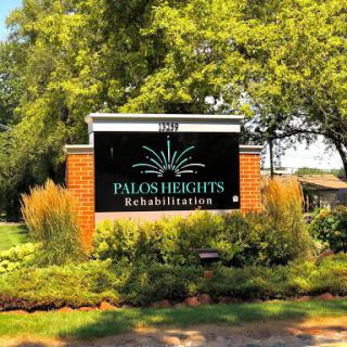 Welcome sign for Palos Heights Rehabilitation, surrounded by lush landscaping.