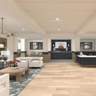 A modern and spacious lobby with comfortable seating areas and a reception desk.