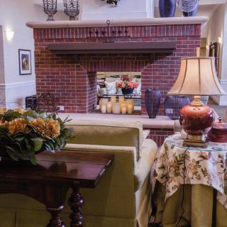 A cozy living room featuring a brick fireplace and elegant decor.