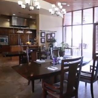 A cozy dining area featuring modern wood furniture and ample natural light.