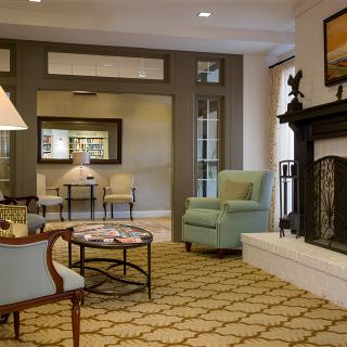 Cozy living room interior with a fireplace and comfortable seating.