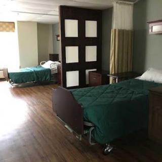 A view of a hospital room featuring two beds, designed for patient care.