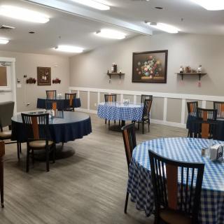 A cozy dining area with checkered tablecloths and simple decor.