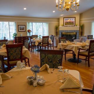 An elegant dining room with neatly arranged tables and chairs, showcasing a sophisticated atmosphere.