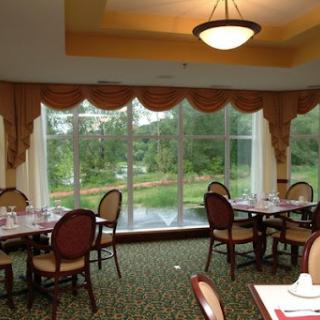 A cozy dining area featuring elegant decor and a view of the surrounding greenery.