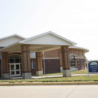 A modern school building with a brick exterior and a covered entrance.
