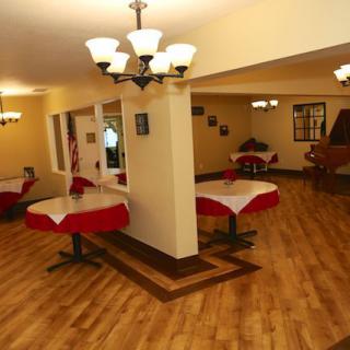 A cozy restaurant dining area with neatly arranged tables and warm lighting.
