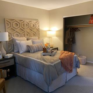 A cozy bedroom with tasteful decor and warm lighting.