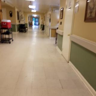 A view of a well-lit hallway in a healthcare facility.