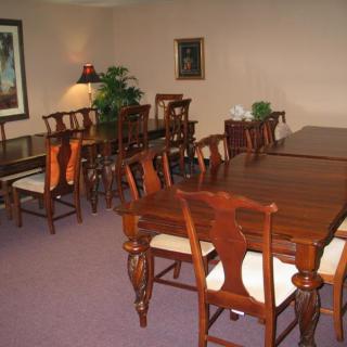 A dining room with wooden furniture, featuring tables and chairs.