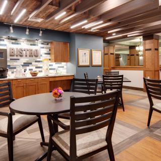 A modern dining space with wooden furniture and cozy overhead lighting.