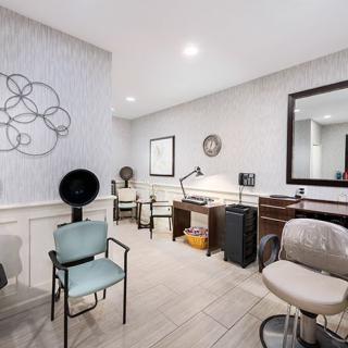 A modern hair salon with stylish decor and comfortable seating.