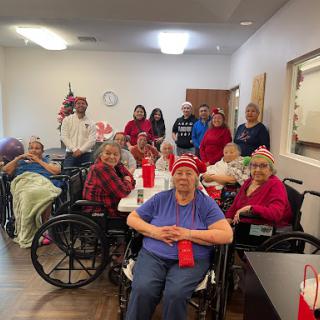 A joyful gathering of residents and staff celebrating together in a nursing home.