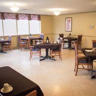 A cozy and inviting dining area with neatly arranged tables and chairs, perfect for meals and gatherings.