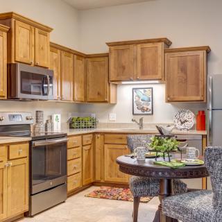 A cozy kitchen with wooden cabinets and stainless steel appliances.