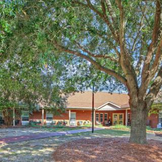 A scenic view of a house surrounded by trees and landscaping.