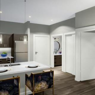 A modern apartment kitchen with a sleek design and a central island.