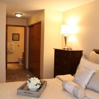 A cozy bedroom with warm lighting and elegant decor.