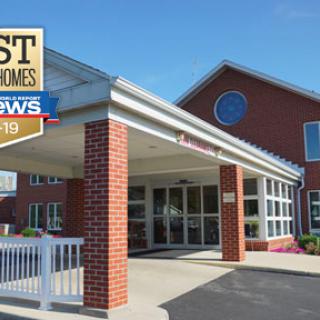 An award-winning nursing home facility with a brick exterior and modern entrance.