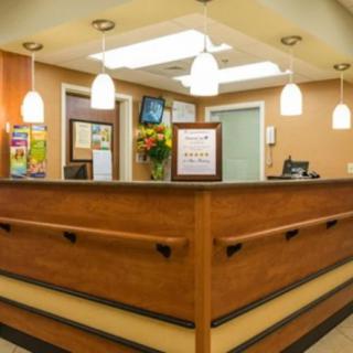 A welcoming reception desk with pendant lighting in a cozy office setting.