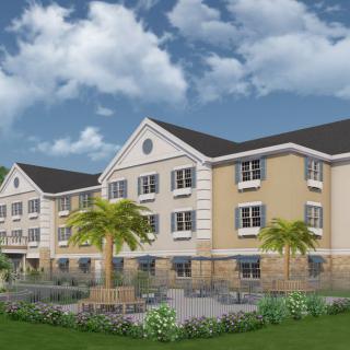 A modern residential apartment building with a landscaped outdoor area and palm trees.