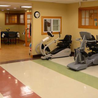 A room featuring exercise equipment, including stationary bikes, likely in a rehabilitation or fitness center.