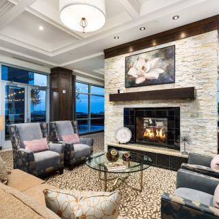 A beautifully designed modern living room featuring a cozy fireplace and elegant furnishings.