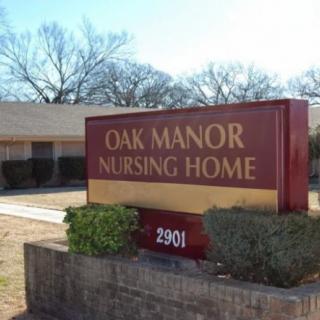 Sign for Oak Manor Nursing Home in front of the building.