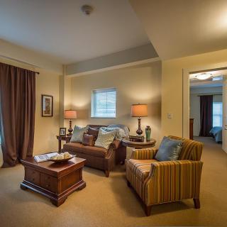 A cozy living room with comfortable seating and warm lighting.