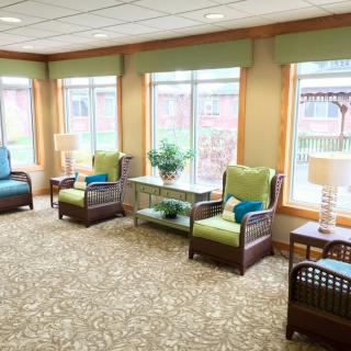 A bright and welcoming waiting area with comfortable seating and large windows allowing natural light to fill the space.