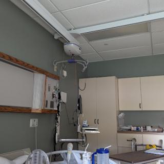 A view of a hospital patient room with medical equipment and a bedside setup.