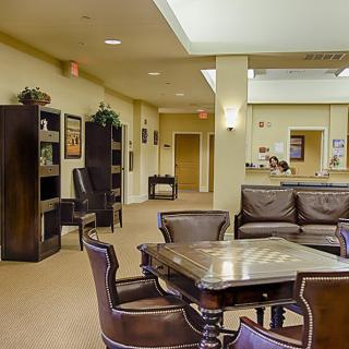 A spacious lobby area featuring comfortable seating and a reception desk.