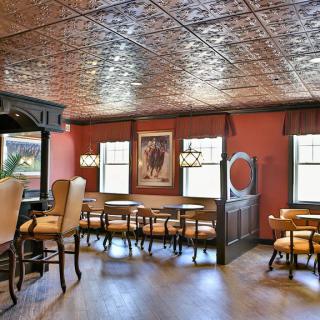 A cozy restaurant interior with vintage decor and wooden furniture.